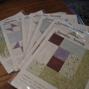 May include: A set of nine quilting patterns for a quilt called "Seamless Serenity". The patterns are printed on white paper with a brown, green, and purple color scheme. The patterns include instructions for making a quilt block.