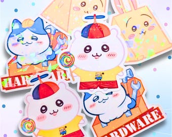 May include: A collection of holographic stickers featuring cartoon animals. The stickers include a cat with a hard hat, a hamster with a propeller hat, and a bunny. Some stickers have the words "HARDWARE" and "HARD" on them. The hamster stickers are holding lollipops.