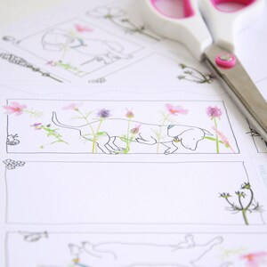 May include: A black and white line drawing of a dachshund sniffing a flower. The dog is surrounded by pink, purple, and white flowers. The image is printed on white cardstock.