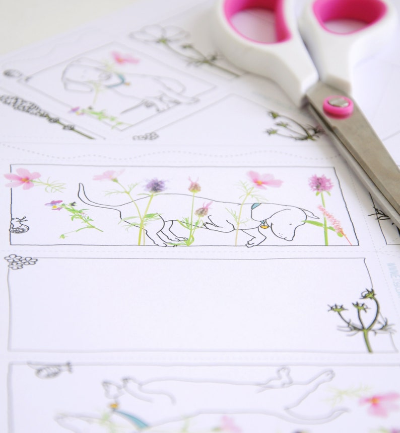 May include: A black and white line drawing of a dachshund sniffing a flower. The dog is surrounded by pink, purple, and white flowers. The image is printed on white cardstock.