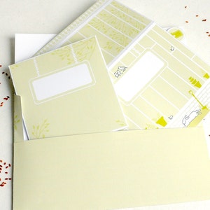 May include: A set of three yellow and white printable cards with a garden theme. The cards have blank spaces for writing and a cute illustration of a bird, a watering can, and a rabbit.