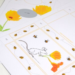 May include: A printable craft activity for kids featuring a white mouse carrying a yellow flower. The craft includes a dotted line path for the mouse to follow, and a set of yellow and black bees to cut out and glue on.