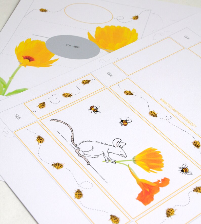 May include: A printable craft activity for kids featuring a white mouse carrying a yellow flower. The craft includes a dotted line path for the mouse to follow, and a set of yellow and black bees to cut out and glue on.