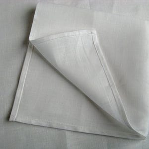 Corner of a white linen napkin with a narrow hem