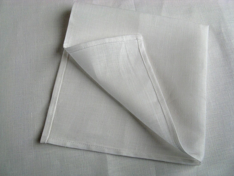 Corner of a white linen napkin with a narrow hem