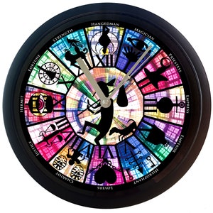 May include: A black clock with a colorful stained glass design featuring the Major Arcana tarot cards. The clock face has Roman numerals and the names of the cards are written around the edge.