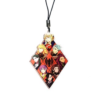 May include: A diamond-shaped acrylic keychain with a black cord. The keychain features a colorful illustration of eight characters from the Fire Emblem: Three Houses video game. The characters are arranged in a grid pattern with a black bird logo in the center.