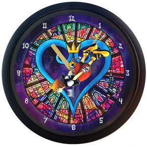 May include: A black wall clock with a stained glass design featuring a blue heart, a keyhole, and a character from the Kingdom Hearts video game series. The clock face has Roman numeral hour markers and Arabic numeral minute markers.
