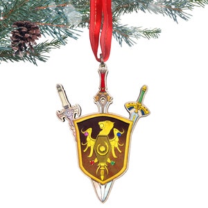 May include: A wooden Christmas ornament featuring a shield with a golden eagle and four swords. The shield is brown with gold accents and the swords are silver, gold, and green.