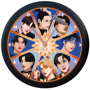 May include: A black clock with a white face and a colorful design. The clock face features a circular design with eight different images of men, each with a different phrase around them. The phrases are: "World Are You There", "Wake Up World Wake Up", "It's Time Lies Continue", "Eyes In The Sky Eyes", "Control Its Time", "Eyes In The Sky Eyes", "Wake Up World Wake Up", and "It's Time Lies Continue".