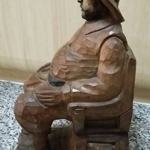 Vintage handcarved wooden sculpture of a seated man. Rustic decor. Folk art.