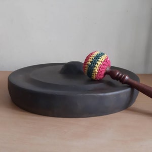 Vintage Indonesian musical gong with striker