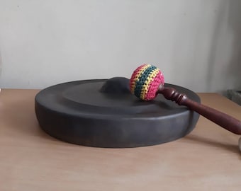 Vintage Indonesian musical gong with striker
