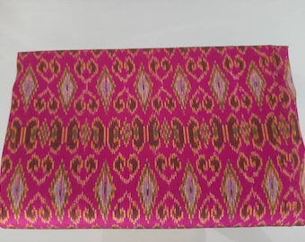Thai Mudmee Silk Textile. Pink background