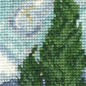 May include: A cross-stitch embroidery depicting a landscape with a tall green tree in the foreground and a blue sky with white clouds in the background.