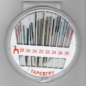 May include: A round plastic case with a white background and red lettering. The case contains a variety of tapestry needles in different sizes, ranging from 22 to 28. The case is labelled "TAPESTRY" in black letters.
