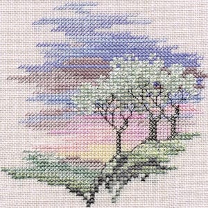 May include: Cross-stitch design depicting a landscape with three trees on a hill, set against a colourful sky. The sky transitions from blue to purple and pink, with green and grey accents. The trees have black branches and green foliage.