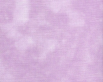 May include: A close-up of a light purple fabric with a subtle white tie-dye pattern. The fabric has a textured, woven appearance.