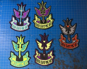May include: Five embroidered patches with a central design of a stylized sword and wings, in various color schemes including purple, yellow, and teal. Each patch has the text "YOU LIFT ME UP" on a banner.