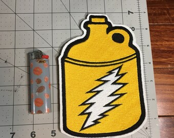 May include: Yellow fabric patch with a black outline, depicting a yellow canteen with a white lightning bolt design. The patch is approximately 5 inches tall.