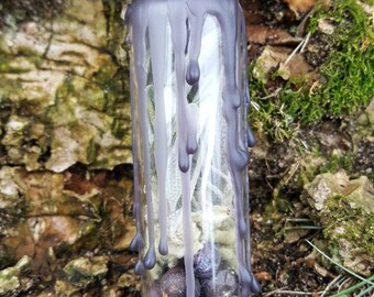 Botella de protección artesanal con hierbas, cristales y piedras.