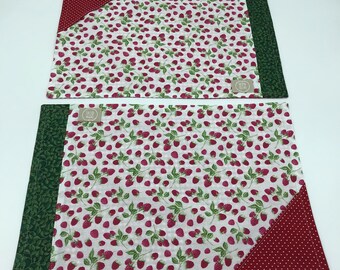 Pair of breakfast placemats with raspberry pattern.