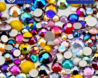 May include: A mix of colorful, iridescent rhinestones in various sizes. The rhinestones are scattered on a white surface. The text "Mix Size" is printed in blue on a white background.