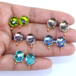 May include: Six pairs of round, faceted glass beads with gold-toned metal loops. The beads are in various colors, including green, purple, blue, and light blue.