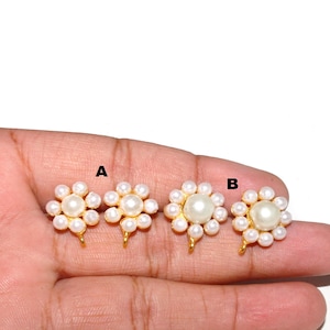 May include: Three gold-toned nose rings with a pearl flower design. The rings are labeled A, B, and C.