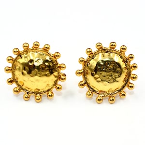 May include: A pair of gold-toned earrings with a hammered circular design and a beaded border.