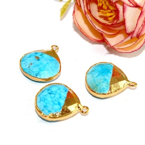 May include: Three turquoise blue and gold teardrop shaped pendant charms with a gold rim. The charms have a textured surface and are perfect for jewelry making.