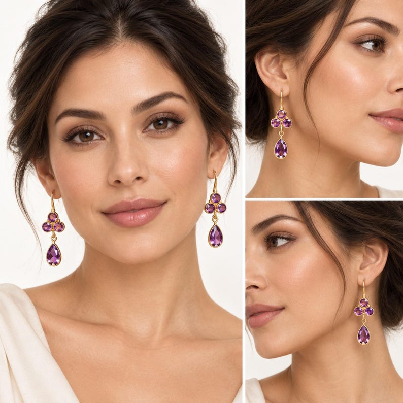 May include: A pair of gold drop earrings featuring three purple amethyst stones arranged in a cluster, with two small round stones at the top and a larger pear-shaped stone dangling below, suspended from a simple gold hook wire mechanism.