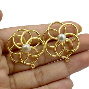 A pair of stylised wire knot earrings