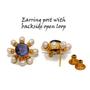 Peut inclure: Une paire de boucles d'oreilles en or avec une pierre pr&eacute;cieuse bleue entour&eacute;e de perles blanches. Les boucles d'oreilles ont un fermoir &agrave; tige avec une boucle ouverte.
