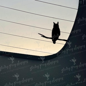 May include: A black silhouette of an owl perched on a branch, set against a backdrop of horizontal lines and a gradient sky. The owl is facing forward, with its ears visible. The image has a minimalist design.