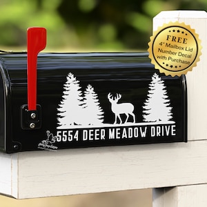 May include: Black mailbox with a white deer, pine trees, and the text "5554 Deer Meadow Drive". A gold sticker with the text "FREE 4" Mailbox Lid Number Decal with Purchase" is on the mailbox.