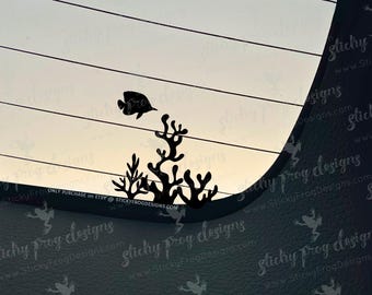 May include: Black silhouette of a fish swimming above coral. The design is set against a light background with horizontal lines. Text at the bottom reads "ONLY PURCHASE on ETSY @ STICKYFROGDESIGNS.COM".