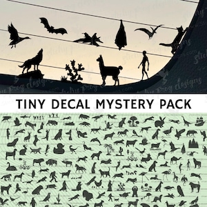 May include: A collection of black silhouette decals featuring various animals, plants, and figures. The top portion includes a wolf, llama, bat, and other shapes. The text "TINY DECAL MYSTERY PACK" is displayed below the silhouettes.