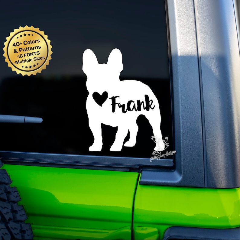 Puede incluir: Calcoman&iacute;a de vinilo blanco con la silueta de un Bulldog Franc&eacute;s con el nombre "Frank" y un coraz&oacute;n en el lateral. La calcoman&iacute;a est&aacute; en la ventana de un coche verde.