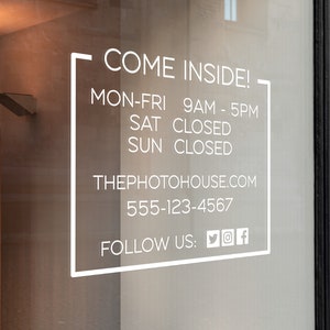 May include: A white sign on a glass door with the text 'COME INSIDE!'  'MON-FRI 9AM - 5PM' 'SAT CLOSED' 'SUN CLOSED' 'THEPHOTOHOUSE.COM' '555-123-4567' 'FOLLOW US: of'.
