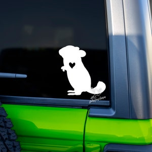May include: White silhouette of a chinchilla with a small heart on its chest. The silhouette is on a black background. The image is a sticker.