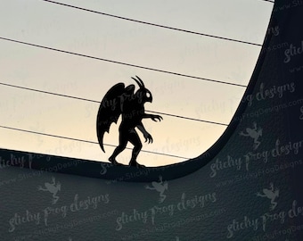 May include: A black silhouette of a gargoyle with large wings, standing on a curved surface. The background shows a gradient of light colors, with horizontal lines. The image has a dark, gothic theme.
