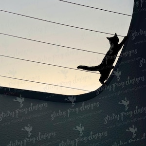 May include: A black cat silhouette climbing a dark surface, set against a backdrop of horizontal lines and a light-colored sky. The cat is reaching upwards, with its body angled. The image has a minimalist aesthetic.