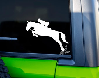 May include: White silhouette of a horse jumping over a fence with a rider on its back. The silhouette is on a black background.
