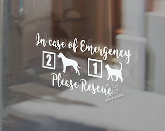 May include: White decal sticker with the text "In case of emergency please rescue" with a silhouette of a dog and a cat. The dog has the number 2 next to it and the cat has the number 1 next to it.