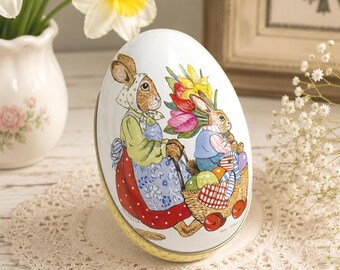 Lata de huevos de Pascua vintage, recipiente metálico con escena de conejito de Guy Untereiner – Caja para dulces
