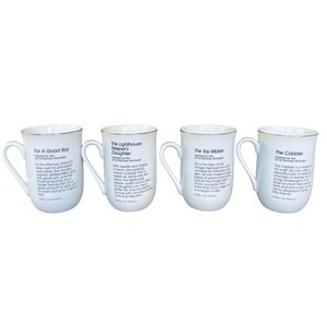 May include: A set of four white ceramic mugs with gold-toned rims and handles. Each mug features black printed text detailing Norman Rockwell inspired stories titled For A Good Boy, The Lighthouse Keeper's Daughter, The Toy Maker, and The Cobbler.