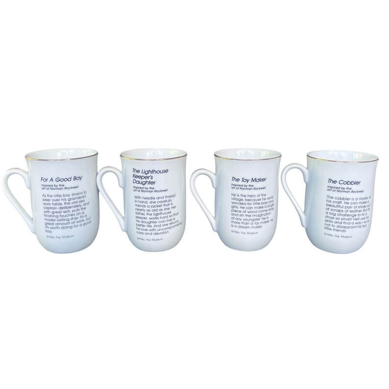 May include: A set of four white ceramic mugs with gold-toned rims and handles. Each mug features black printed text detailing Norman Rockwell inspired stories titled For A Good Boy, The Lighthouse Keeper's Daughter, The Toy Maker, and The Cobbler.