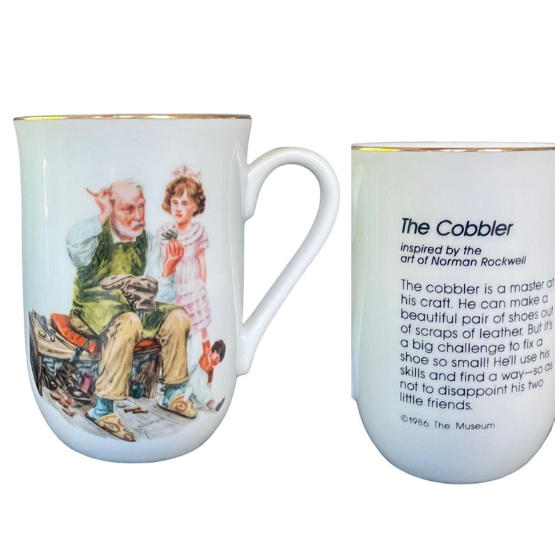 May include: A white ceramic mug with a gold rim featuring a Norman Rockwell illustration of a cobbler working on a shoe with two children nearby. The reverse side displays the text The Cobbler inspired by the art of Norman Rockwell and 1986.