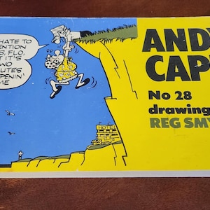 May include: A vintage Andy Capp comic book with a blue and yellow cover. The cover features a cartoon illustration of a man hanging from a cliff, with text bubbles. The title "Andy Capp" is prominently displayed.
